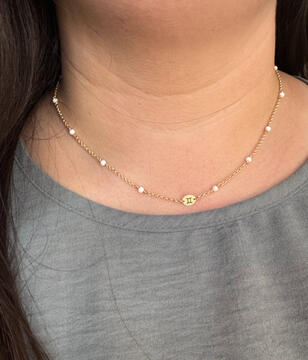 gold and opal necklace with zodiac charm